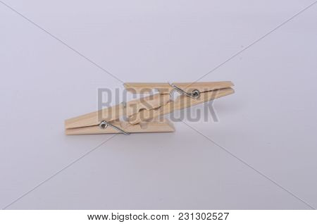 Some Clothespins Making A Chain. It Draws An Abstract 69 Number. Some Wooden Clothespins.