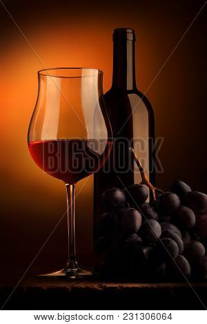 Goblet Of Red Wine With Bottle And Bunch Of Grap