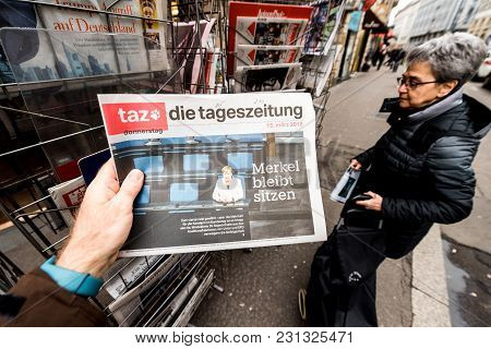 Paris, France - Mar 15, 2017: Man Reading Buying German Die Tageszeitung Newspaper At Press Kiosk Fe