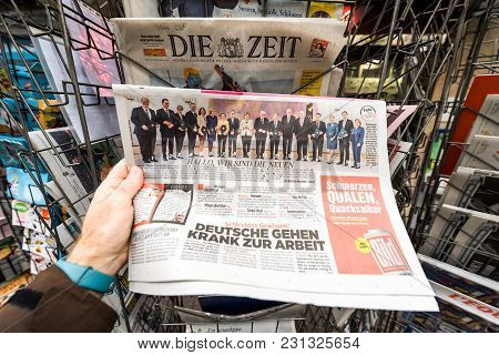 Paris, France - Mar 15, 2017: Man Reading Buying German Newspaper At Press Kiosk Featuring Angela Do