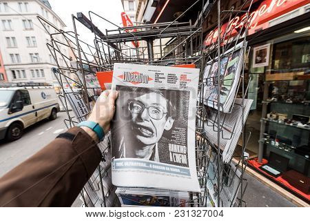 Paris, France - Mar 15, 2018: Man Buying French Liberation Newspaper With Portrait Of Stephen Hawkin