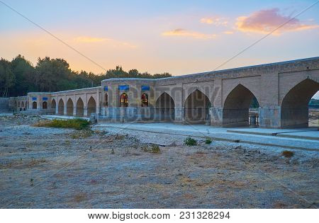 The Sunset Over Medieval Joui Bridge Over The Dried-up Zayandeh River, Isfahan, Iran.
