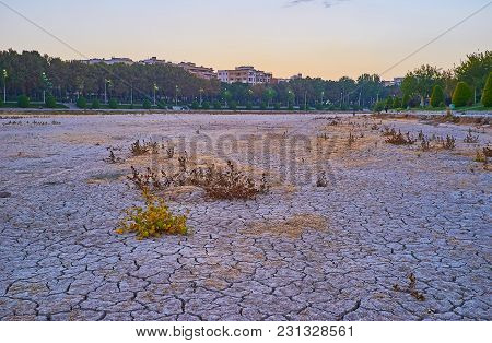 The Sunset Sky Over The Dried-up Zayandeh River With Cracked Mud On Its Bottom And Beautiful Riversi