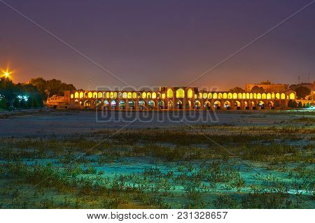 The Walk Along The Dried Up Bottom Of Zayandeh River With A View On Bright Khaju Bridge With Numerou