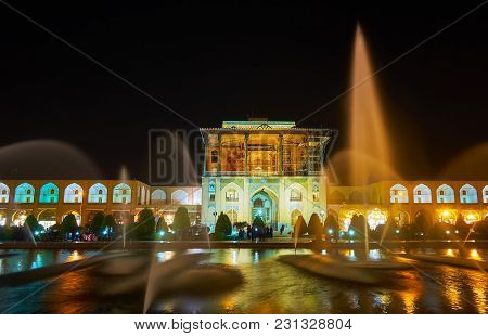 Isfahan, Iran - October 20, 2017: The View On Brightly Illuminated Qapu Palace Through The Beautiful