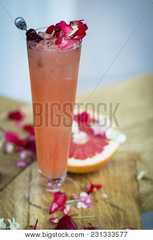 Pink, Bright Cocktail With Grapefruit, Decorated With Flowers