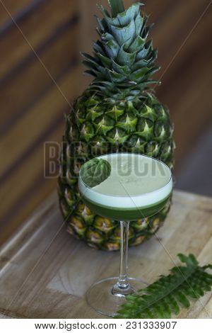 Bright, Summer,  Green Cocktail With Pineapple  On The Wooden Table