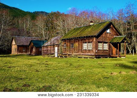 Rustic Wooden Cabins With Moss On The Roof Taken At The Temperate Hoh Rain Forest In Olympic Nationa