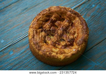 Round Loaf Karavai On Wooden Rustic Table Background. Traditional Slavic Russian And Ukranian Festiv