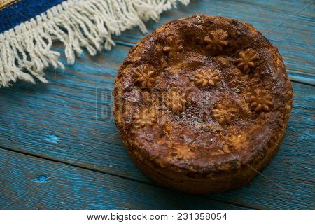 Round Loaf Karavai On Wooden Rustic Table Background. Traditional Slavic Russian And Ukranian Festiv