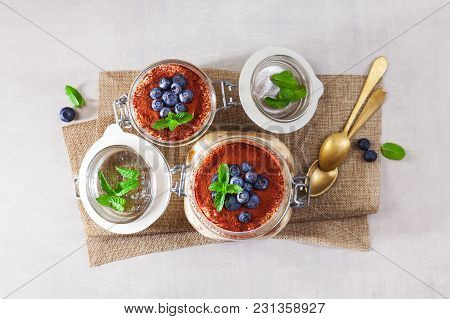 Tiramisu, Traditional Italian Dessert. With Savoyardi Cookies And Coffee. On White Table. In Differe