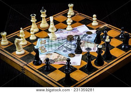 Chess Board With Cash And Chess On A Dark Background