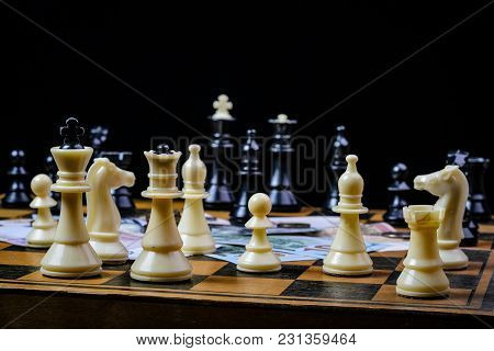 Chess Board With Cash And Chess On A Dark Background