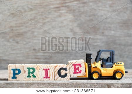 Toy Forklift Hold Letter Block E To Complete Word Price On Wood Background