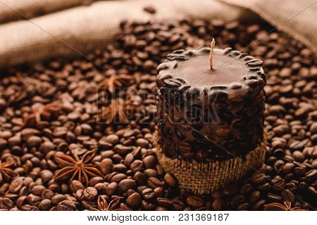 Brown Handmade Candle With Coffee Beans, Anise Stars And Sackcloth Background