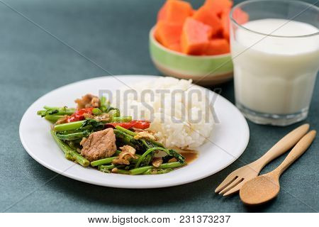 Thai Food, Stir Fried Morning Glory (pad Pak Boong) With Cooked Rice On Dish, Glass Of Milk And Piec