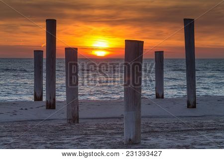 Wooden Piles On An Empty Beach And A Beautiful Sunset Sky Over The Sea, Petten, Holland,north Sea