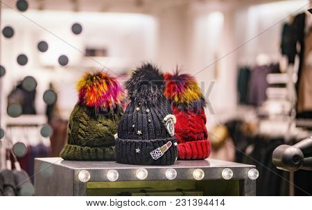 Three Knitted Hats On A Self In A Shop Showcase