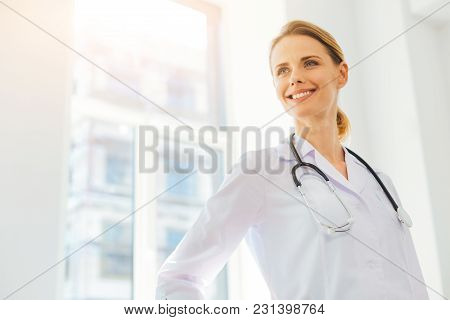 Positivity Is The Key To Success. Low Angle Shot Of A Radiant Young Lady In A Labcoat Grinning Broad