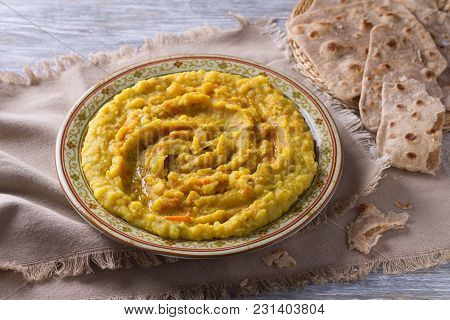 Stewed Yellow Peas With Carrots, Onions And Spices On A Wooden Table With Chapatti, Selective Focus