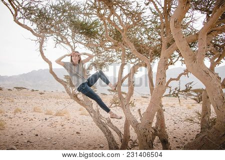 Pretty Girl Have Fun On A Tree In The Desert In A Day