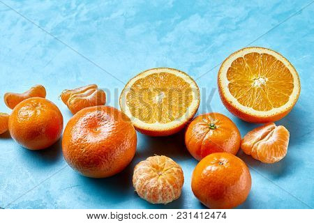 Variety Of Fresh Citrus For Making Juice Or Smoothie Over Blue Textured Background, Topview, Selecti