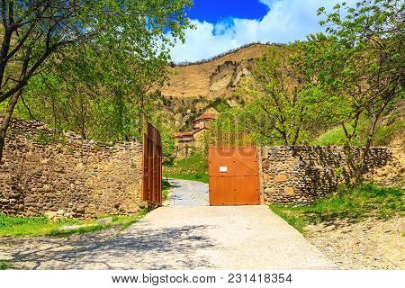 Entrance View Of Ancient Shio-mgvime Monastery With Road And Mountains Near Mtskheta, Georgia