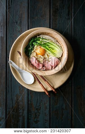 Asian Dish Udon Noodles With Egg Yolk, Sesame, Mushrooms, Boc Choy, Sliced Sous Vide Cooked Meat Ser