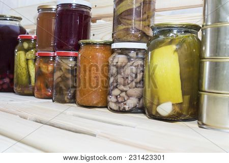 Storage Shelves In Pantry With Homemade Canned Preserved Fruits And Vegetables.