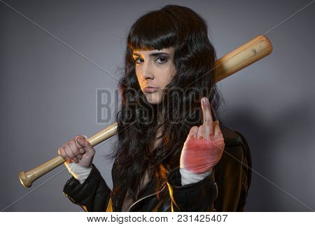 lawbreaker, adolescence and delinquency, brunette woman in leather jacket and baseball bat with challenging aptitude