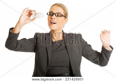 Beautiful businesswoman with plane toy in hand