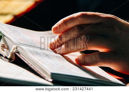 Voyutyn, Volyn / Ukraine - October 14 2008: Hand Of Priest On The Bible. Shallow Depth Of  Fielf.