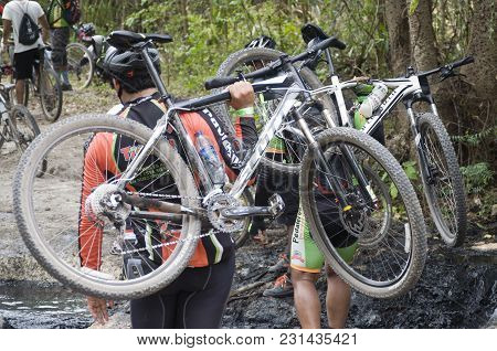 San Pedro Macoris, Dominican Republic - Mar 19, 2017: Unidentified Mountainbikers Crossing Mayen Lag