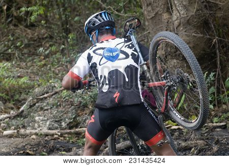 San Pedro Macoris, Dominican Republic - Mar 19, 2017: Unidentified Mountainbiker Crossing Mayen Lago