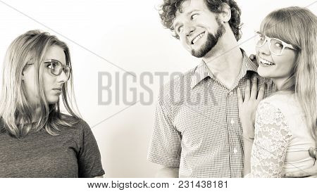 Jealousy And Betrayal Concept. Abandoned Jelous Girl Watching On Happy Hugging Couple. Triangle Rela