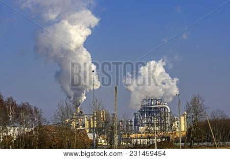 A Vast, Flat Area. In The Distance You Can See A Factory, A Shiny Metal Structure .. From The Chimne