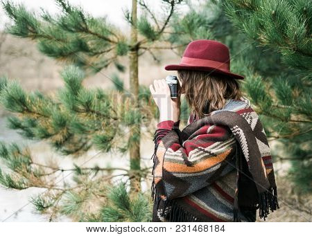 Young Woman Photographing In A Forest Holding A Vintage Camera. Kinfolk / Outdoors Style.