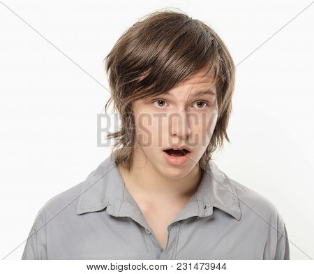 Young Boy In Grey Shirt Is Surprised.
