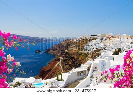 Oia, Traditional Greek Village With Flowers And Aegan Sea Waters, Santorini, Greece