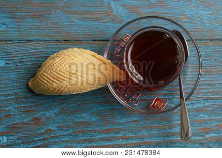 Glass Of Tea With Azerbaijan Pastry Shekerbura And Wheat Grass Semeni On Blue Wooden Table Backgroun
