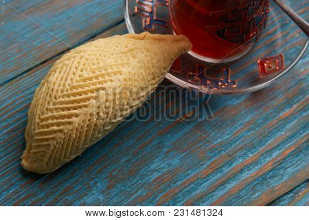 National Azerbaijan Pastry Shekerbura With Nuts And Honey And Glass Of Black Tea On Wooden Table Wit
