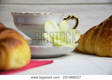 Vintage Coffee Cup With Espresso On A Saucer, Croissant On The Rose Table-napkin, Green Orchid Flowe