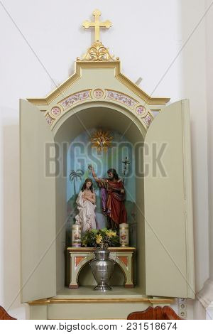 SISAK, CROATIA - DECEMBER 07: Baptism of the Jesus, statue in the Church of Holy Cross in Sisak, Croatia, on December 07, 2017.