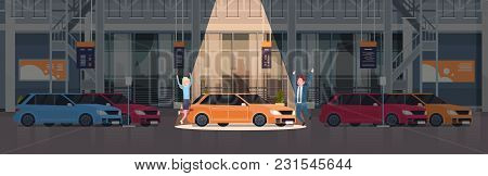 Couple Of Seller Presenting New Car In Dealership Center Showroom Over Set Of New Vechicles Horizont