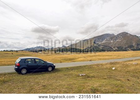 Zabljak, Montenegro - September 19: Car With The Traveler Stands On The Roadside In A Yellow Field I