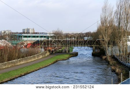 A Metal Bridge Carrying Pipes Over The Canal In Wigan