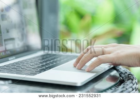 Asian Woman Hands And Married Ring Has Touching And Typing On Laptop Computer With Blurred Coffee, C