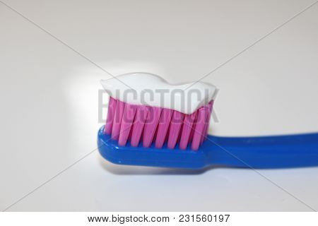 Toothbrush On A White Background. A Toothbrush With Different Colors. Medical And Healtcare Objects.