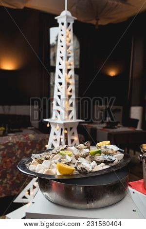 Fresh Oyster Served On White Stones On A Tray In A Restaurant