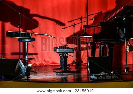A Piano And A Guitar On Stage Before The Concert Unusual Lighting Conditions